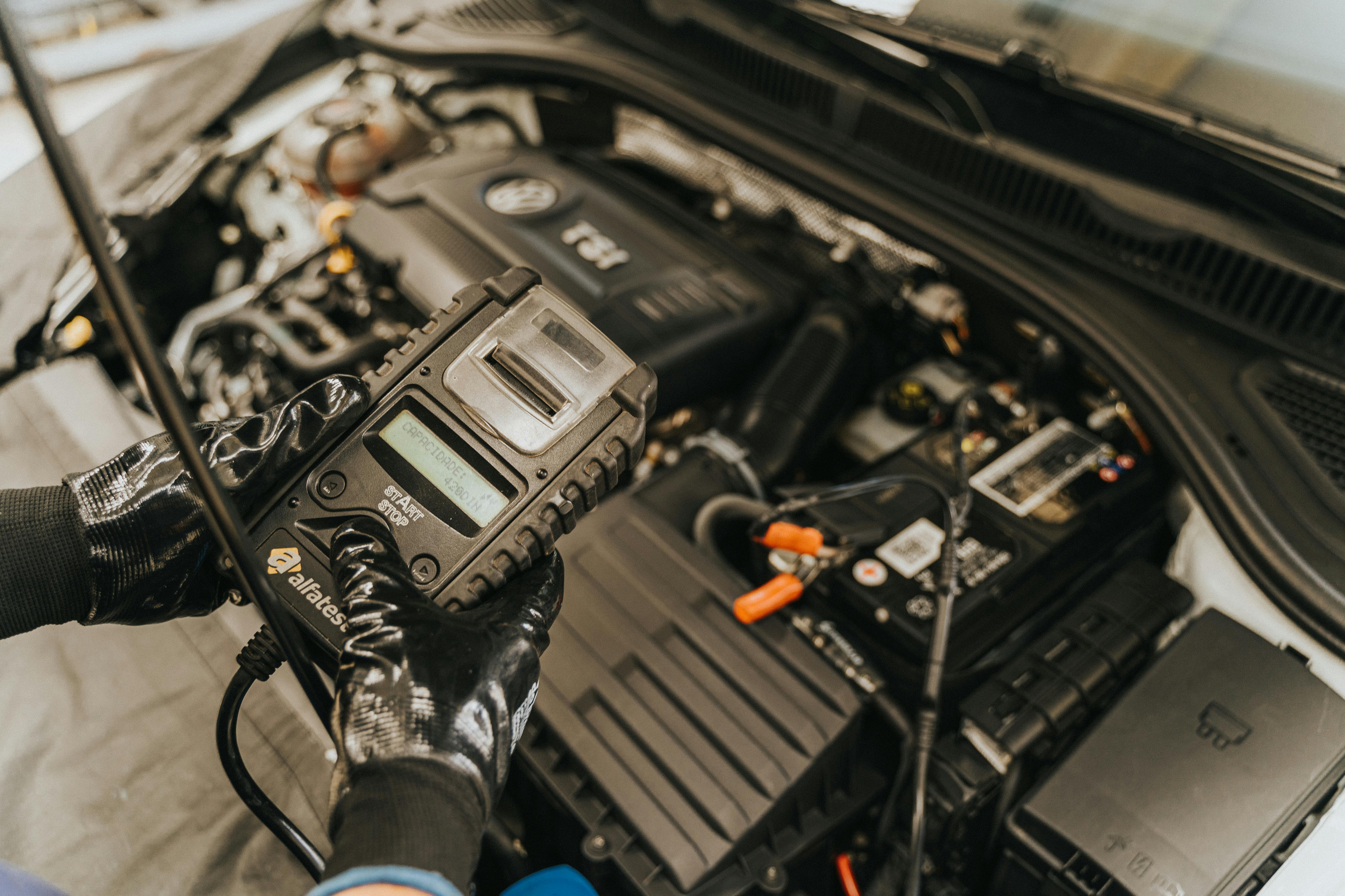 Diagnostic scanner connected in an open engine bay during fault-code checks.