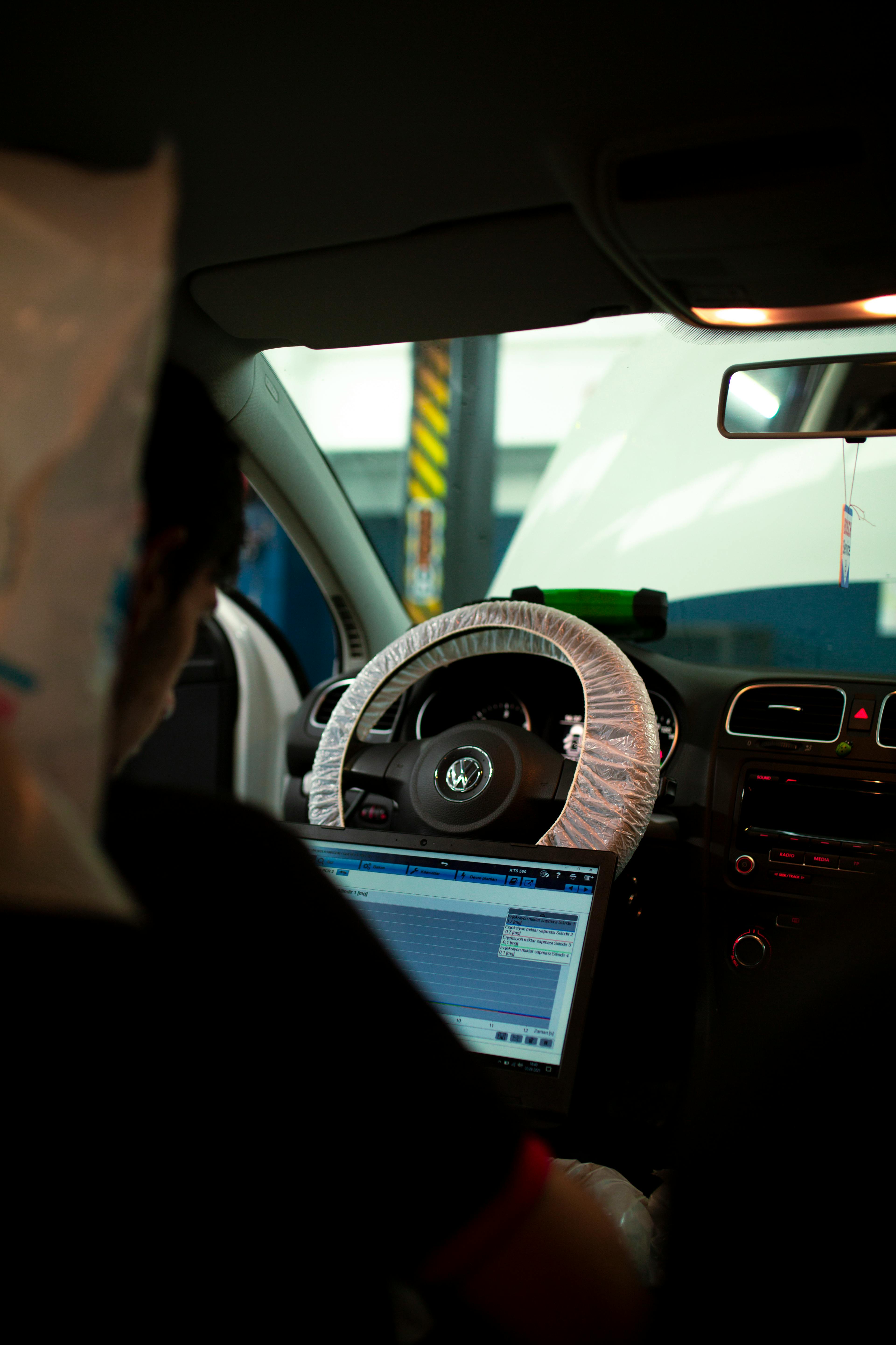 Laptop used inside the vehicle for dashboard fault-code diagnostics.